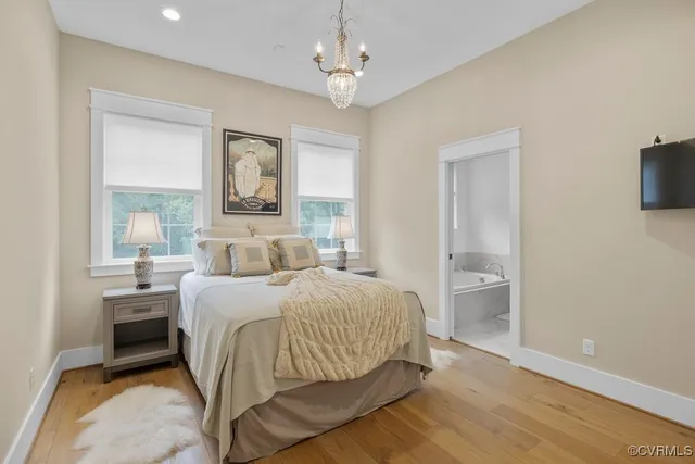 a bathroom with a granite countertop sink and a bathtub