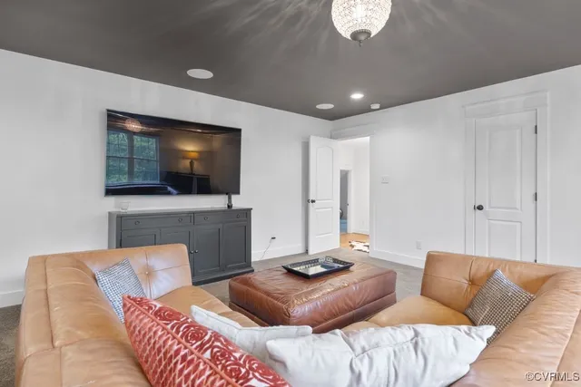 a view of a room with chairs and chandelier