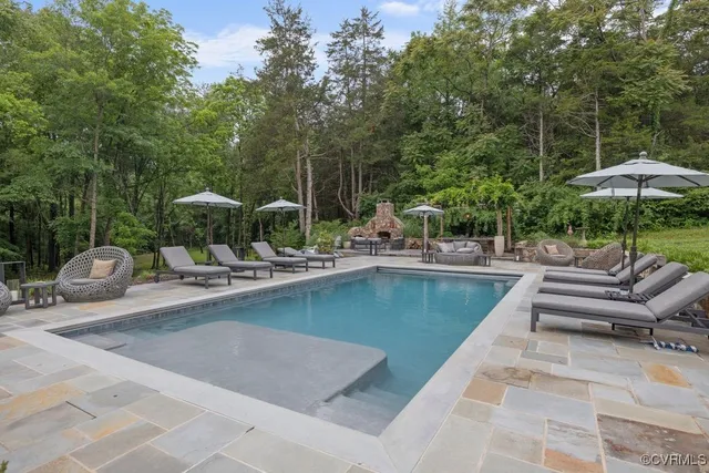 a view of patio with chairs and umbrella