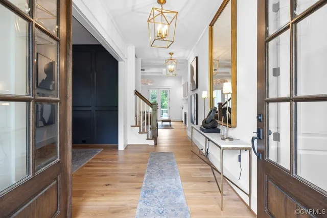 a view of a hallway with wooden floor and staircase