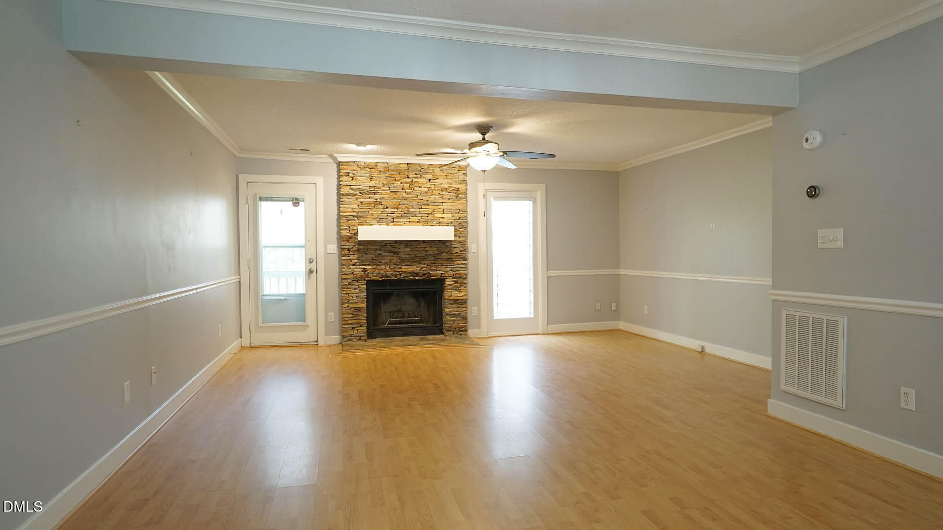 1427 Quarter Point Raleigh, NC 27615 - Photo 11 of 38 an empty room with wooden floor fireplace and windows