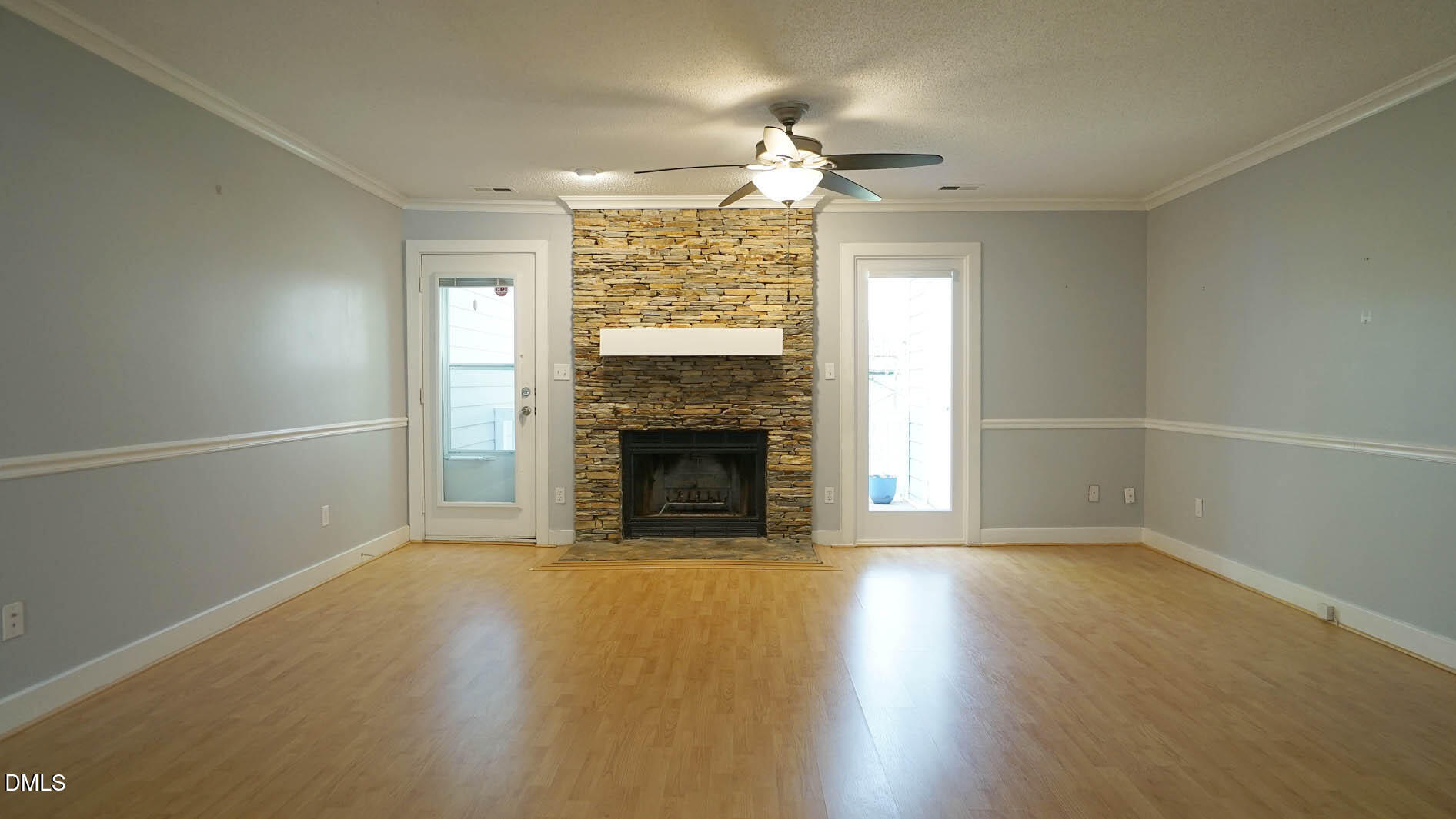 1427 Quarter Point Raleigh, NC 27615 - Photo 12 of 38 an empty room with wooden floor fireplace and windows