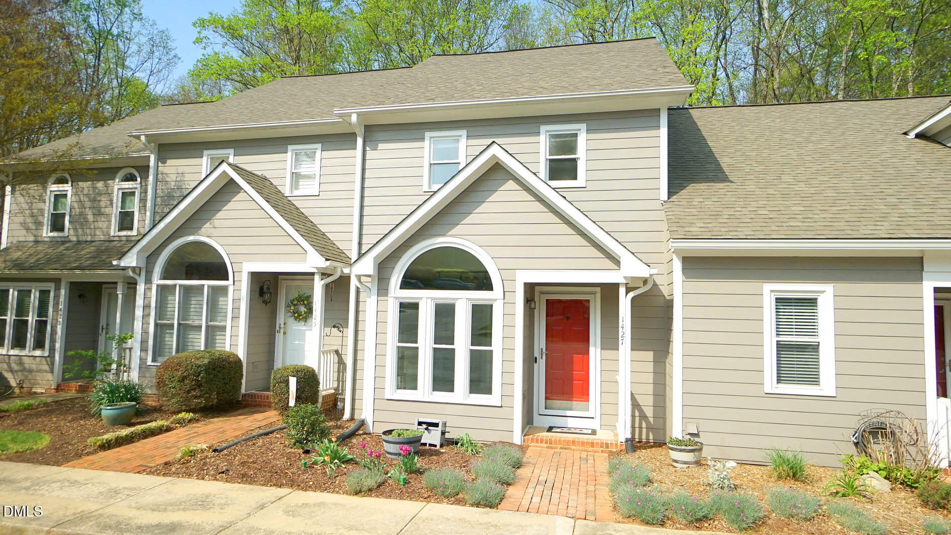 1427 Quarter Point Raleigh, NC 27615 - Photo 2 of 38 a front view of a house with a yard