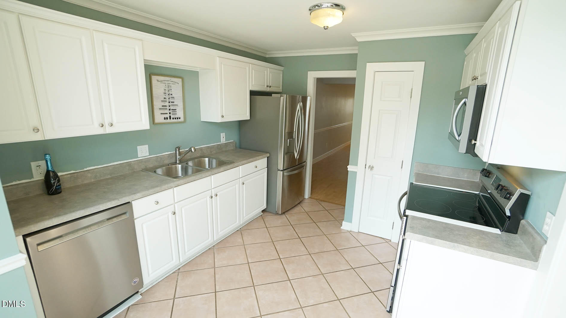 1427 Quarter Point Raleigh, NC 27615 - Photo 4 of 38 a kitchen with a sink and a refrigerator