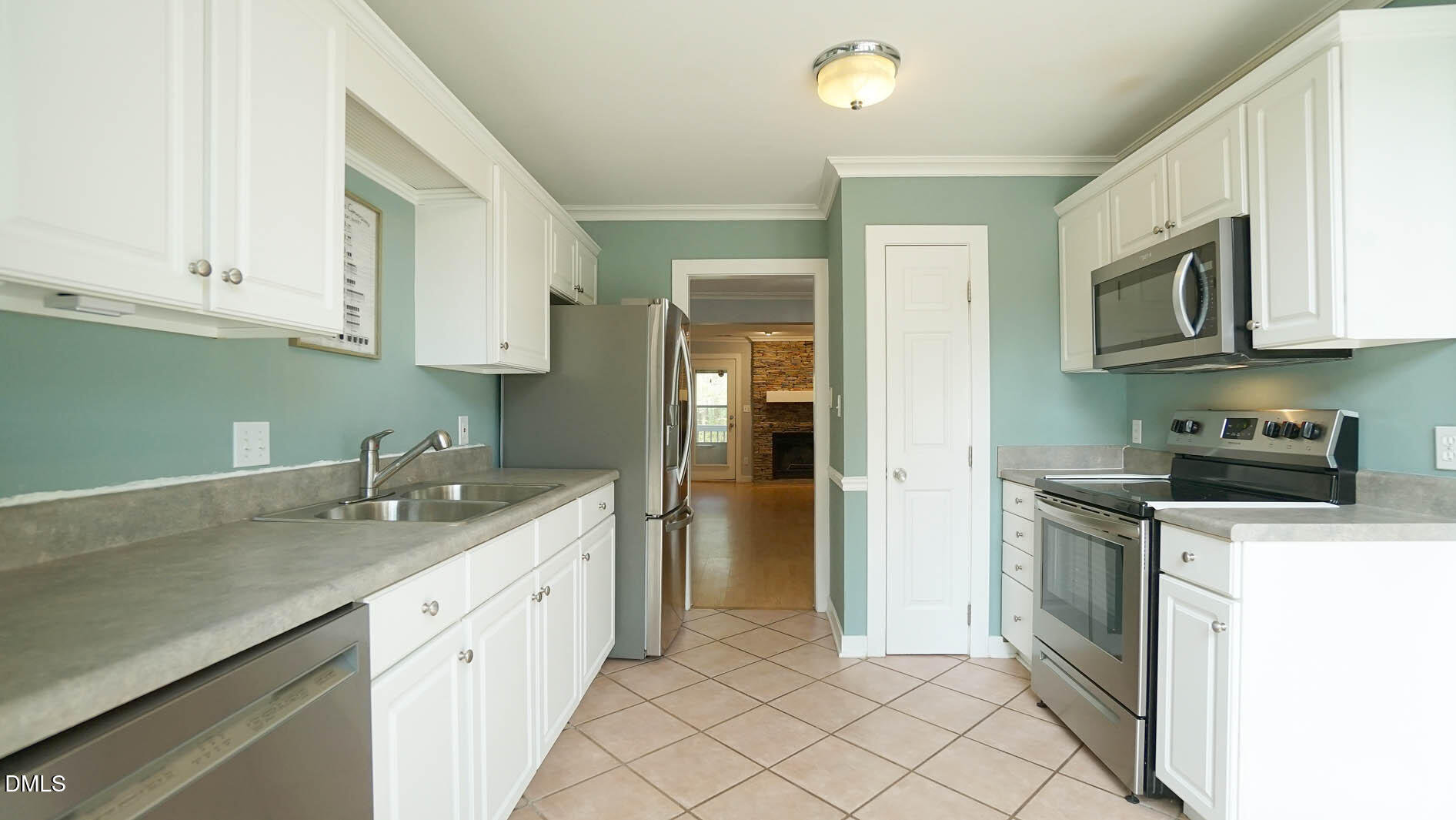 1427 Quarter Point Raleigh, NC 27615 - Photo 5 of 38 a kitchen with granite countertop white cabinets and stainless steel appliances