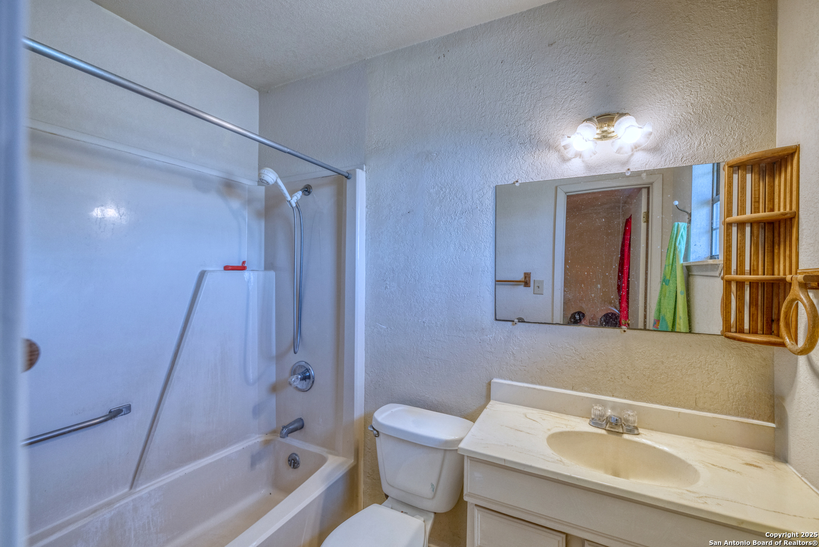 1390 Windmill Road Uvalde, TX 78801 - Photo 15 of 44 a bathroom with a sink a toilet and shower