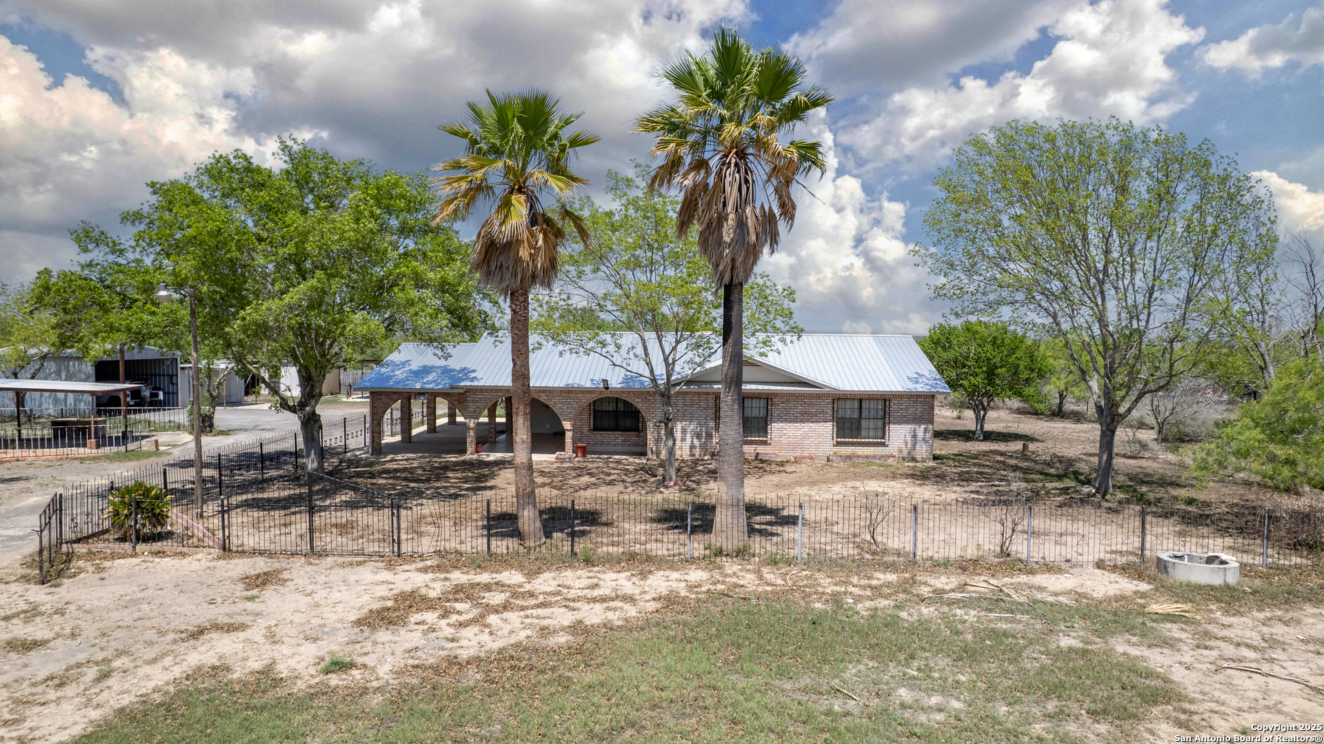1390 Windmill Road Uvalde, TX 78801 - Photo 2 of 44 a front view of a house with swimming pool
