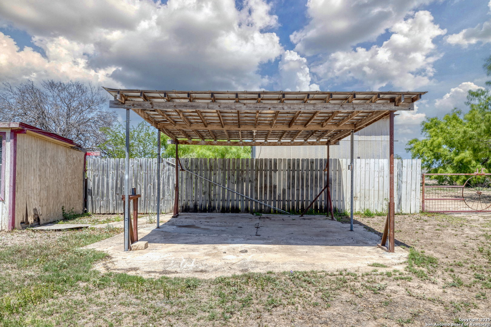 1390 Windmill Road Uvalde, TX 78801 - Photo 22 of 44 a view of a dry yard with wooden fence