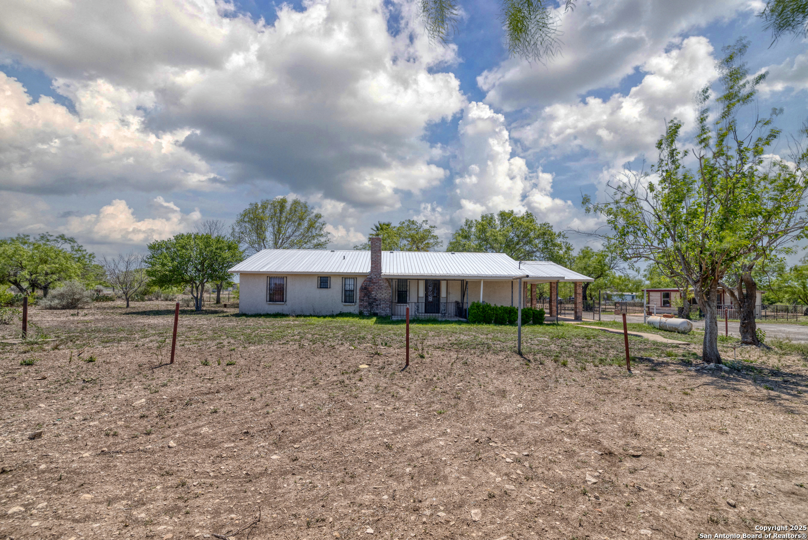 1390 Windmill Road Uvalde, TX 78801 - Photo 27 of 44 a view of a house with a yard and wooden fence