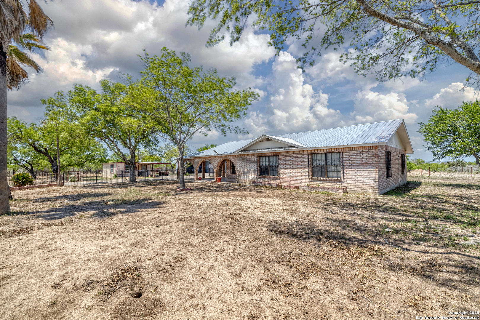 1390 Windmill Road Uvalde, TX 78801 - Photo 31 of 44 a front view of a house with a yard