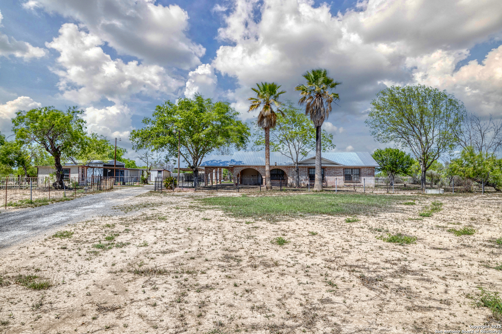 1390 Windmill Road Uvalde, TX 78801 - Photo 32 of 44 a view of a yard with a house