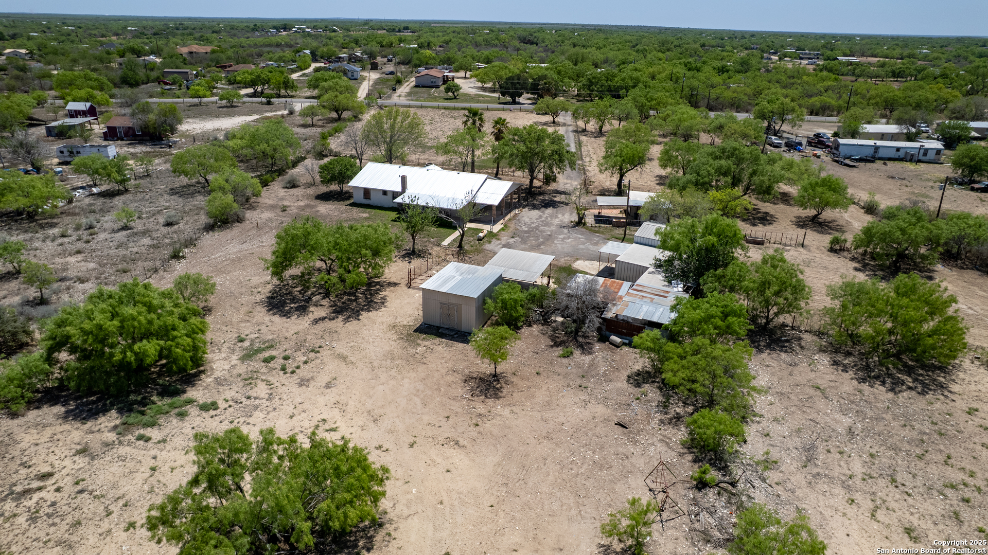 1390 Windmill Road Uvalde, TX 78801 - Photo 37 of 44 an aerial view of a house with a yard and lake view