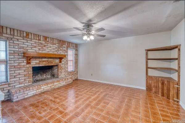 a view of an empty room with a fireplace