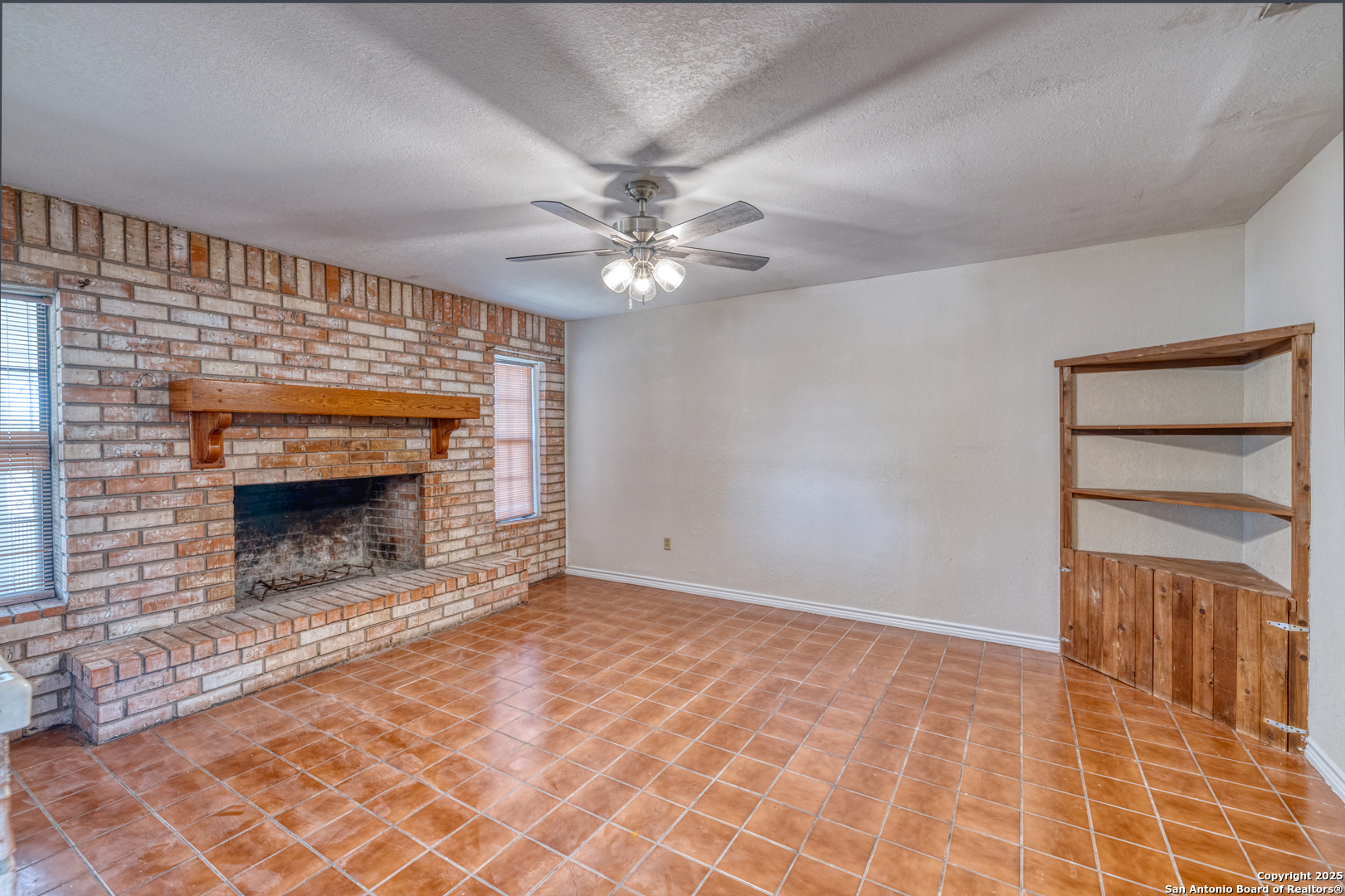 1390 Windmill Road Uvalde, TX 78801 - Photo 10 of 44 a view of an empty room with a fireplace