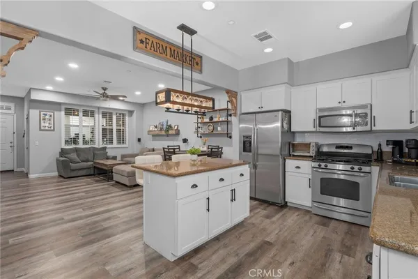 a kitchen with stainless steel appliances a stove refrigerator sink and microwave