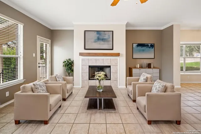 a view of an empty room with window and a fireplace