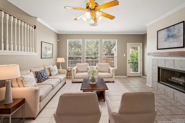 a view of an empty room with window and fire place