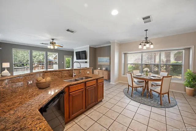 a room with a large window and chandelier