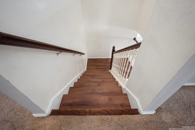 a living room with furniture potted plant and windows