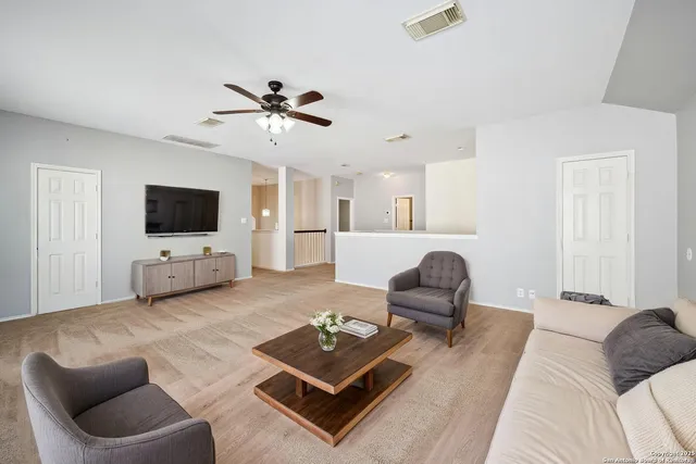 a view of a kitchen with a ceiling fan and a hardwood floor