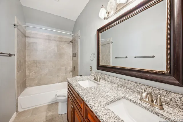 an empty room with chandelier fan and windows