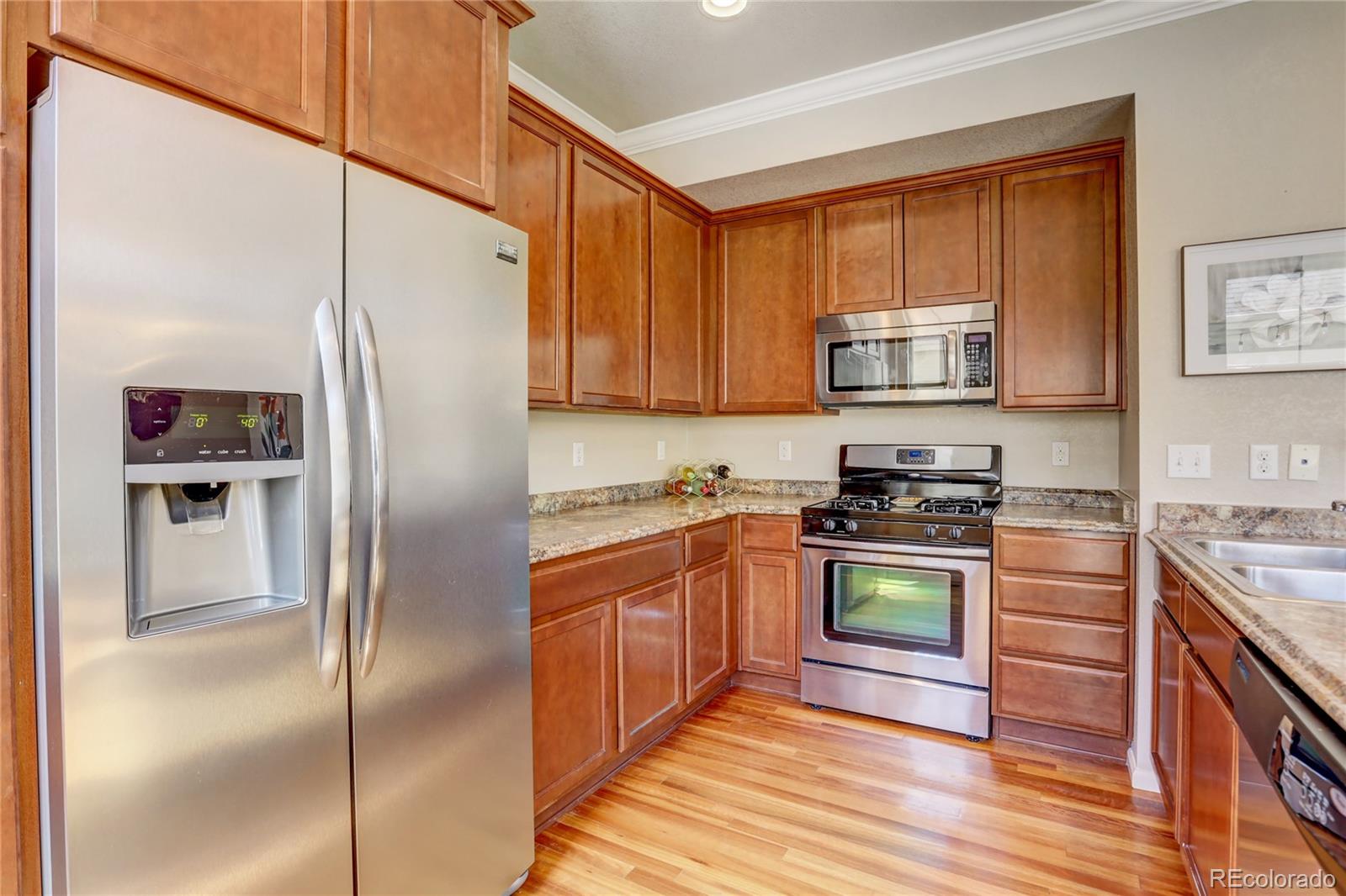 10321 Bellwether Lane Lone Tree, CO 80124 - Photo 12 of 32 a kitchen with stainless steel appliances granite countertop a refrigerator stove and sink