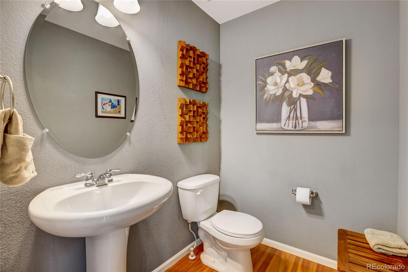 10321 Bellwether Lane Lone Tree, CO 80124 - Photo 14 of 32 a bathroom with a toilet a sink and mirror