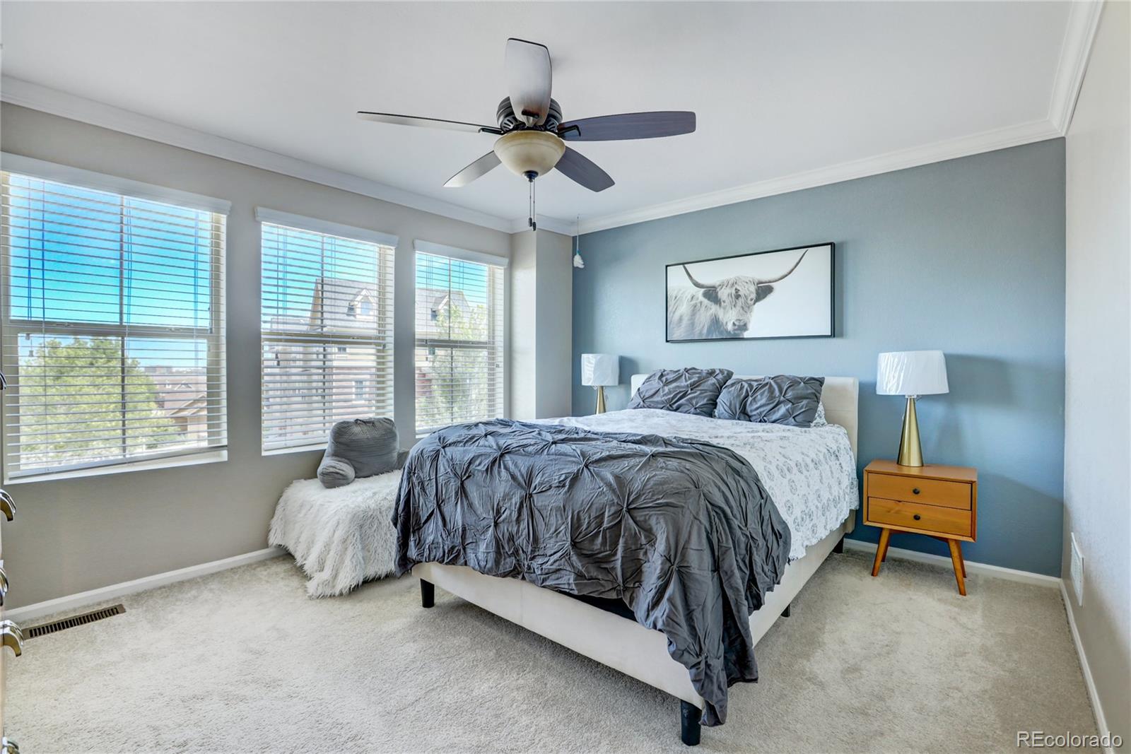 10321 Bellwether Lane Lone Tree, CO 80124 - Photo 17 of 32 a spacious bedroom with a bed and a chandelier