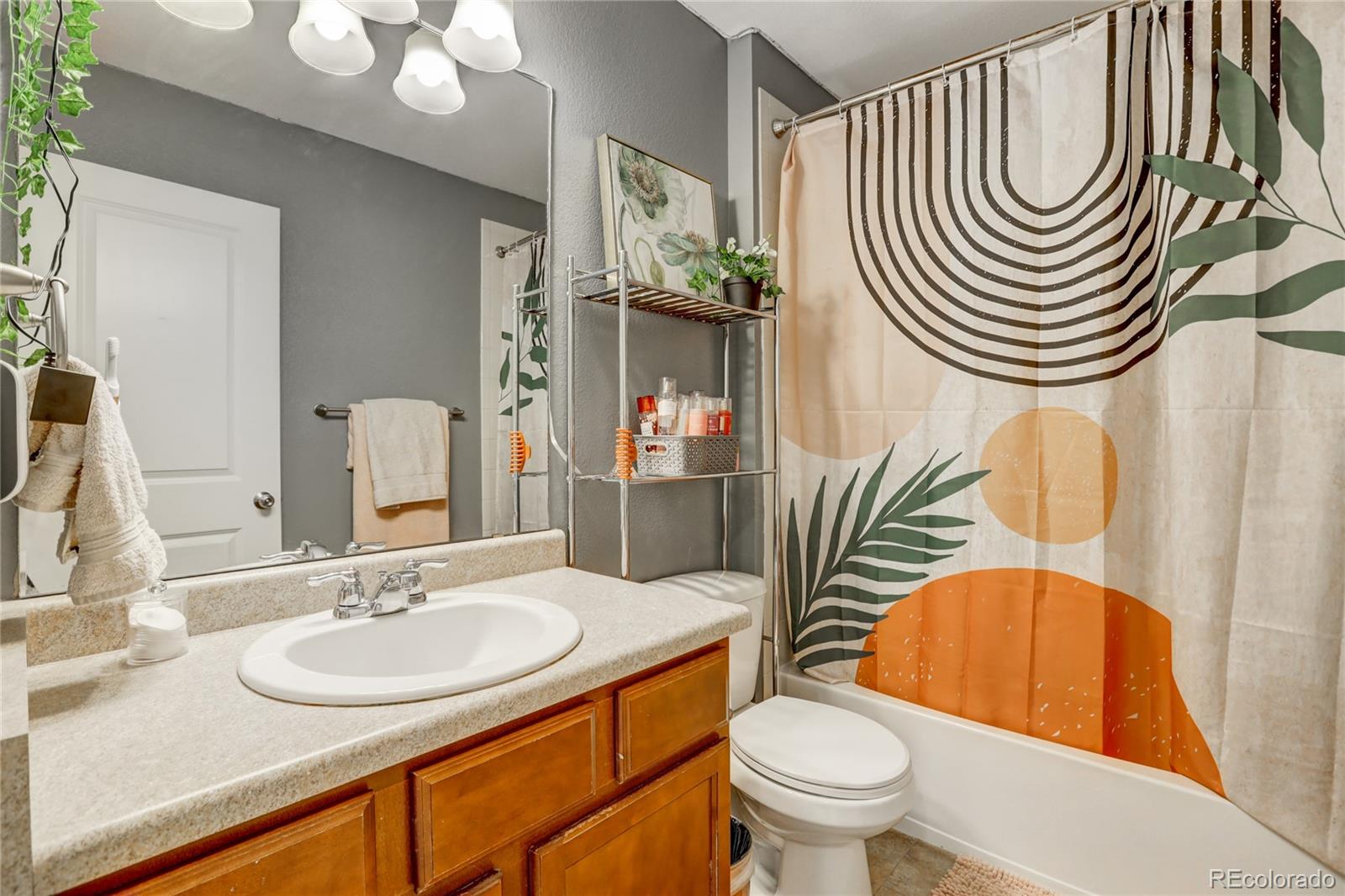 10321 Bellwether Lane Lone Tree, CO 80124 - Photo 21 of 32 a bathroom with a sink a toilet and a mirror