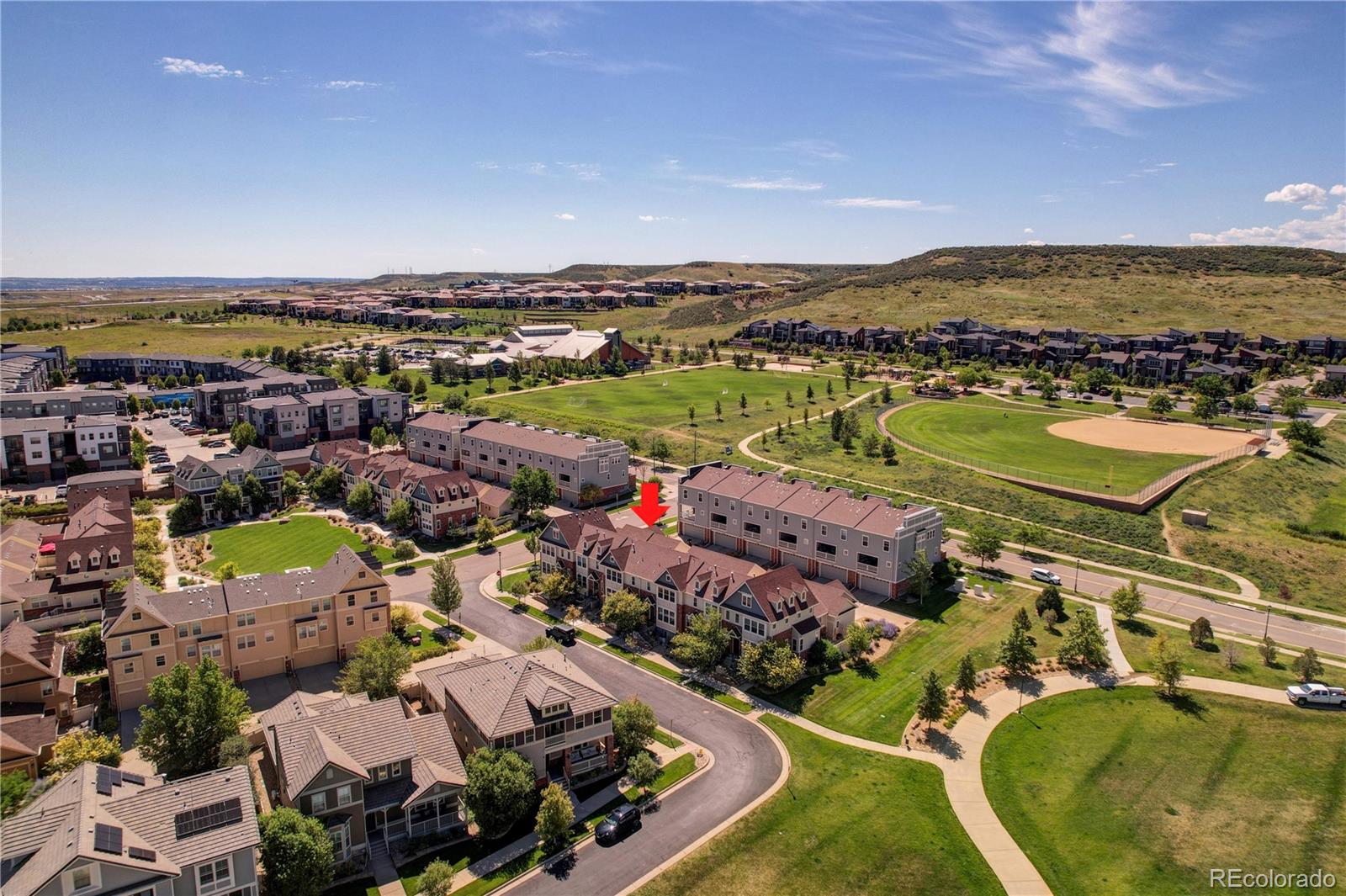 10321 Bellwether Lane Lone Tree, CO 80124 - Photo 29 of 32 an aerial view of a city with lots of residential buildings and mountain view in back