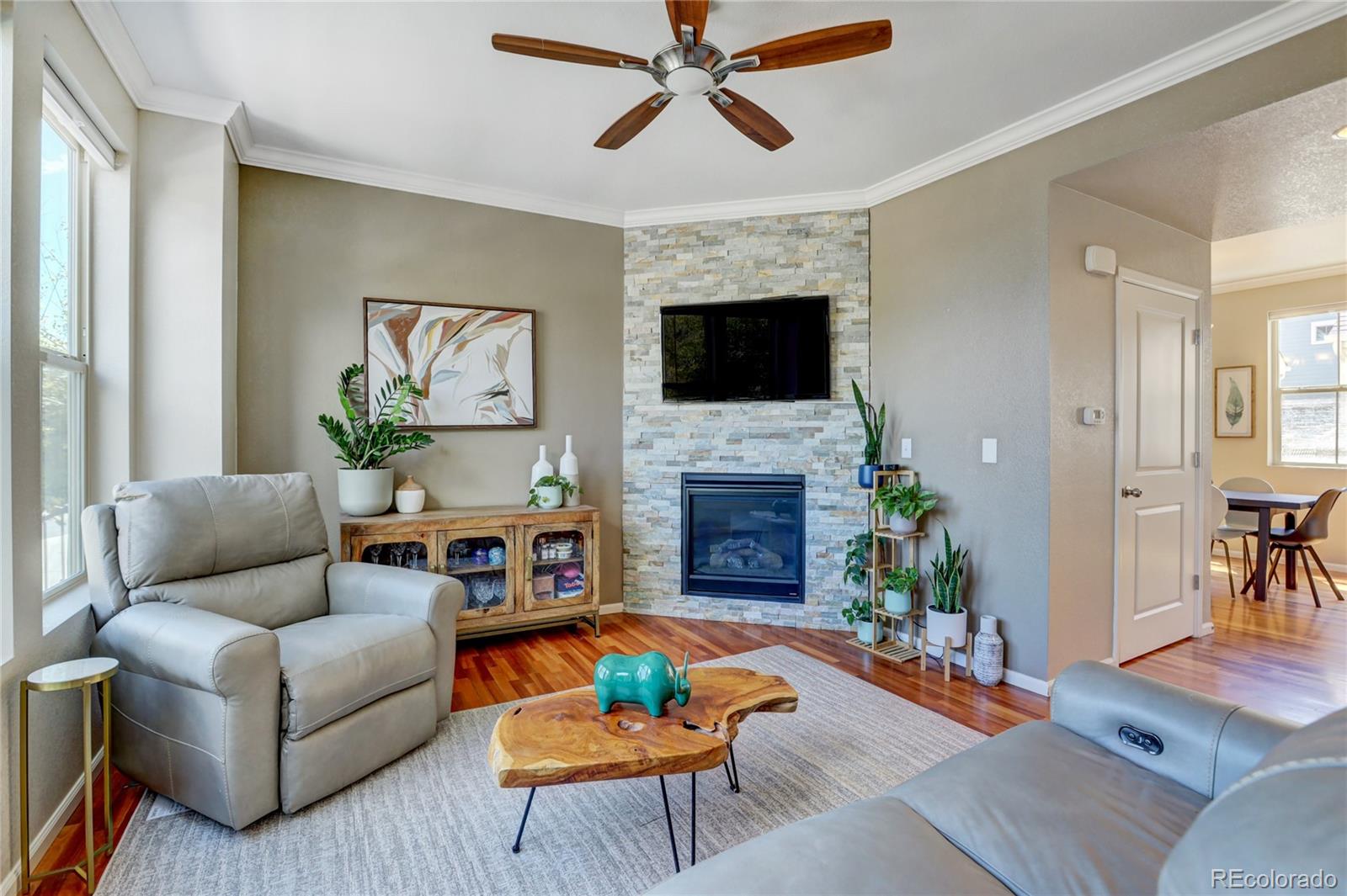 10321 Bellwether Lane Lone Tree, CO 80124 - Photo 5 of 32 a living room with furniture a fireplace and a flat screen tv