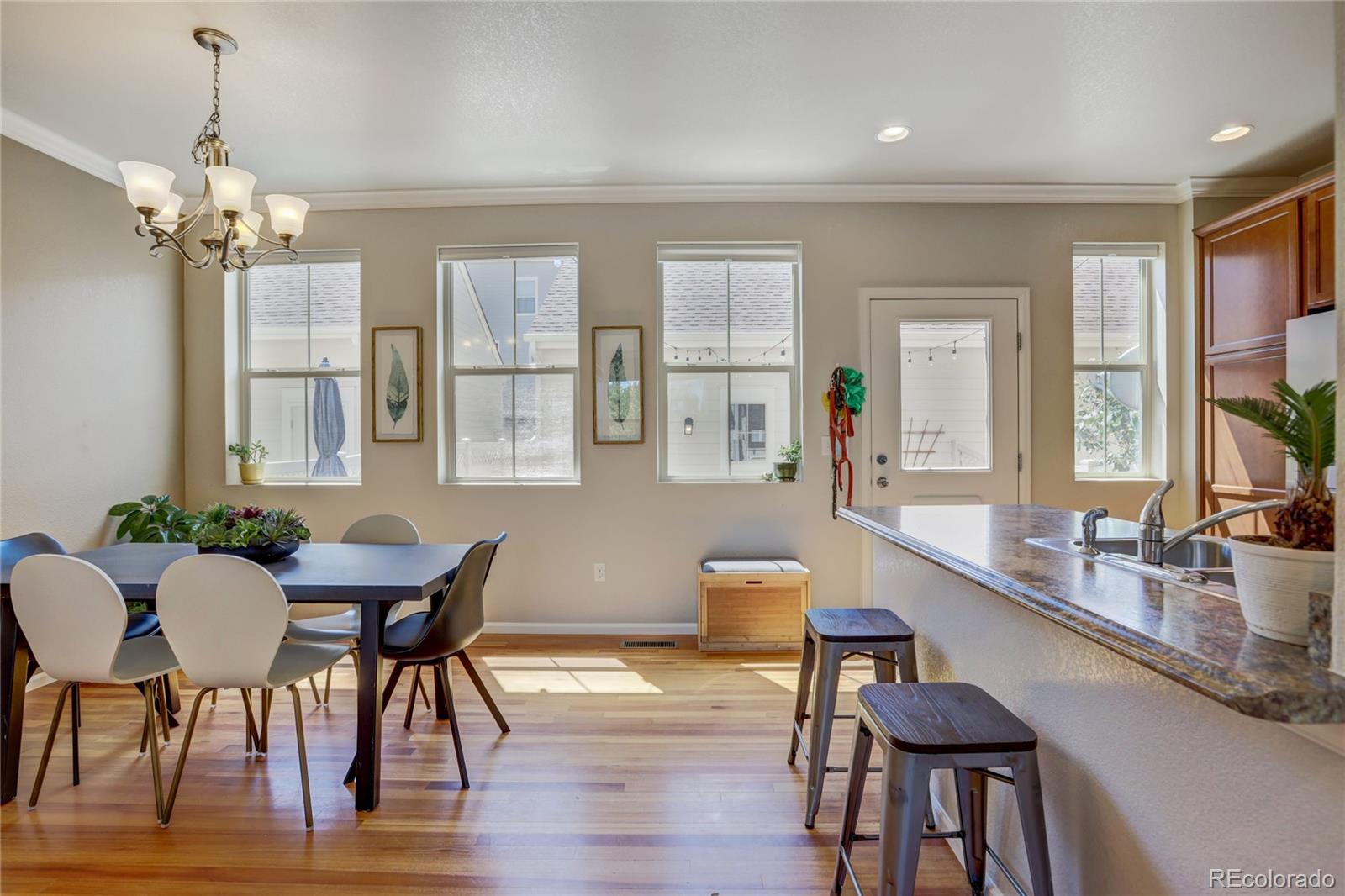 10321 Bellwether Lane Lone Tree, CO 80124 - Photo 7 of 32 a view of a dining room with furniture window and wooden floor