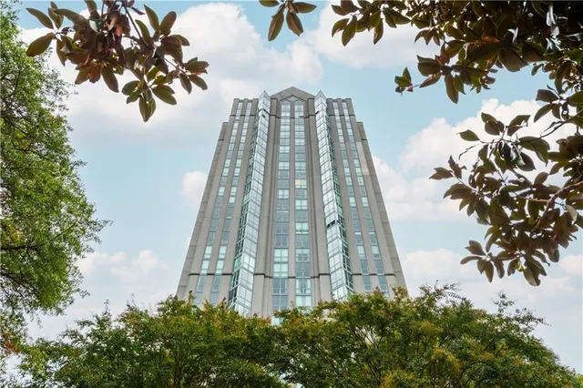 a kitchen with stainless steel appliances a stove a sink dishwasher a refrigerator and microwave with wooden floor