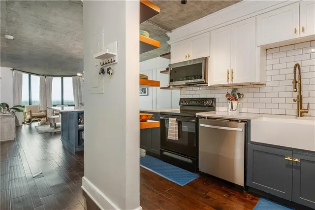 a kitchen with stainless steel appliances granite countertop a refrigerator and a stove