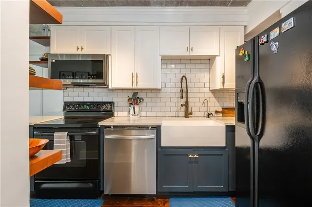 a kitchen with stainless steel appliances granite countertop a refrigerator and a stove top oven