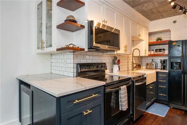 a kitchen with stainless steel appliances granite countertop a stove and a sink