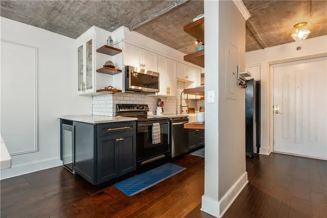 a room with a table chairs and a painting on the wall