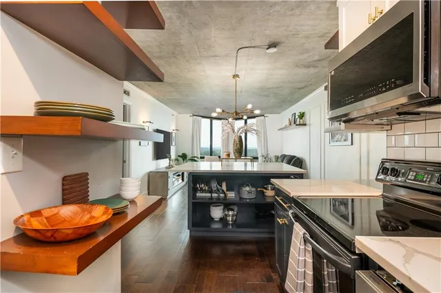 a living room with furniture a large window and a flat screen tv