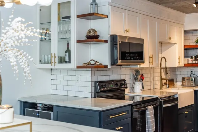 a kitchen with stainless steel appliances a stove and a microwave