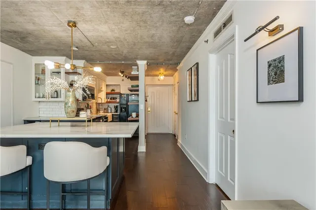 a view of a hallway with couch and wooden floor