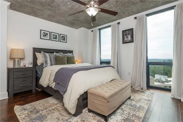 a bedroom with a large bed and a chandelier