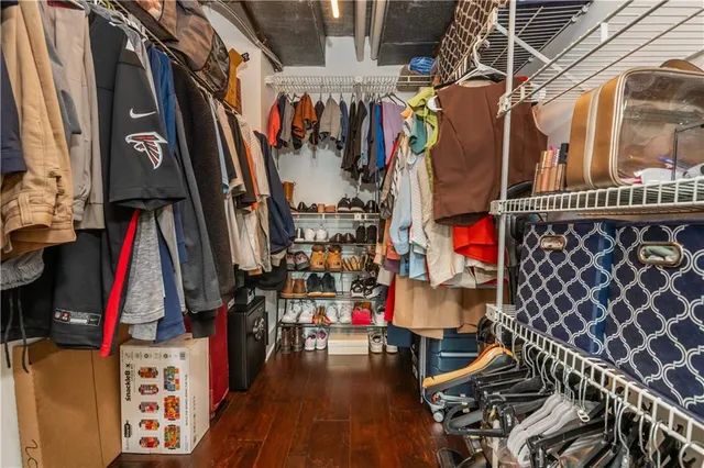 a view of a tennis ground with large trees