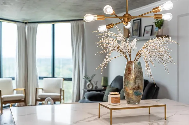 a kitchen with a wooden floor and a view of living room