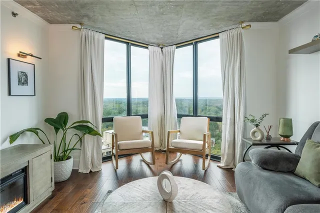 a view of dining room with kitchen island a potted plant and a stove