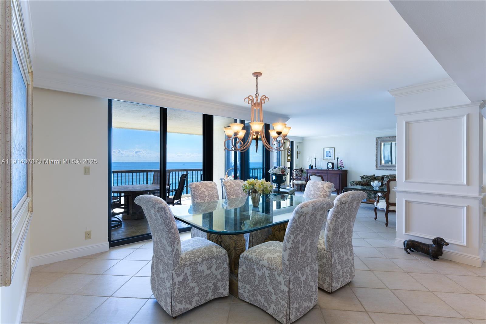 19670 South Beach Road, Unit PHB3 Tequesta, FL 33469 - Photo 16 of 38 a dining room with furniture and a chandelier
