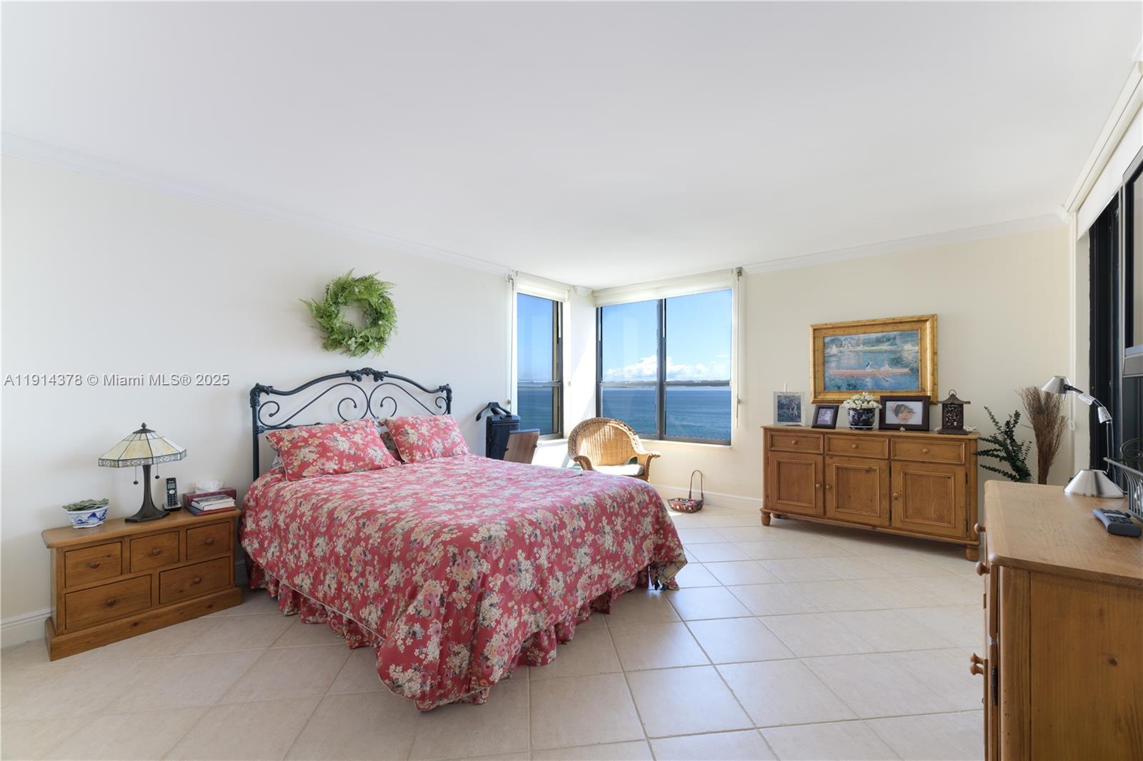 19670 South Beach Road, Unit PHB3 Tequesta, FL 33469 - Photo 24 of 38 a bedroom with a bed and a couch