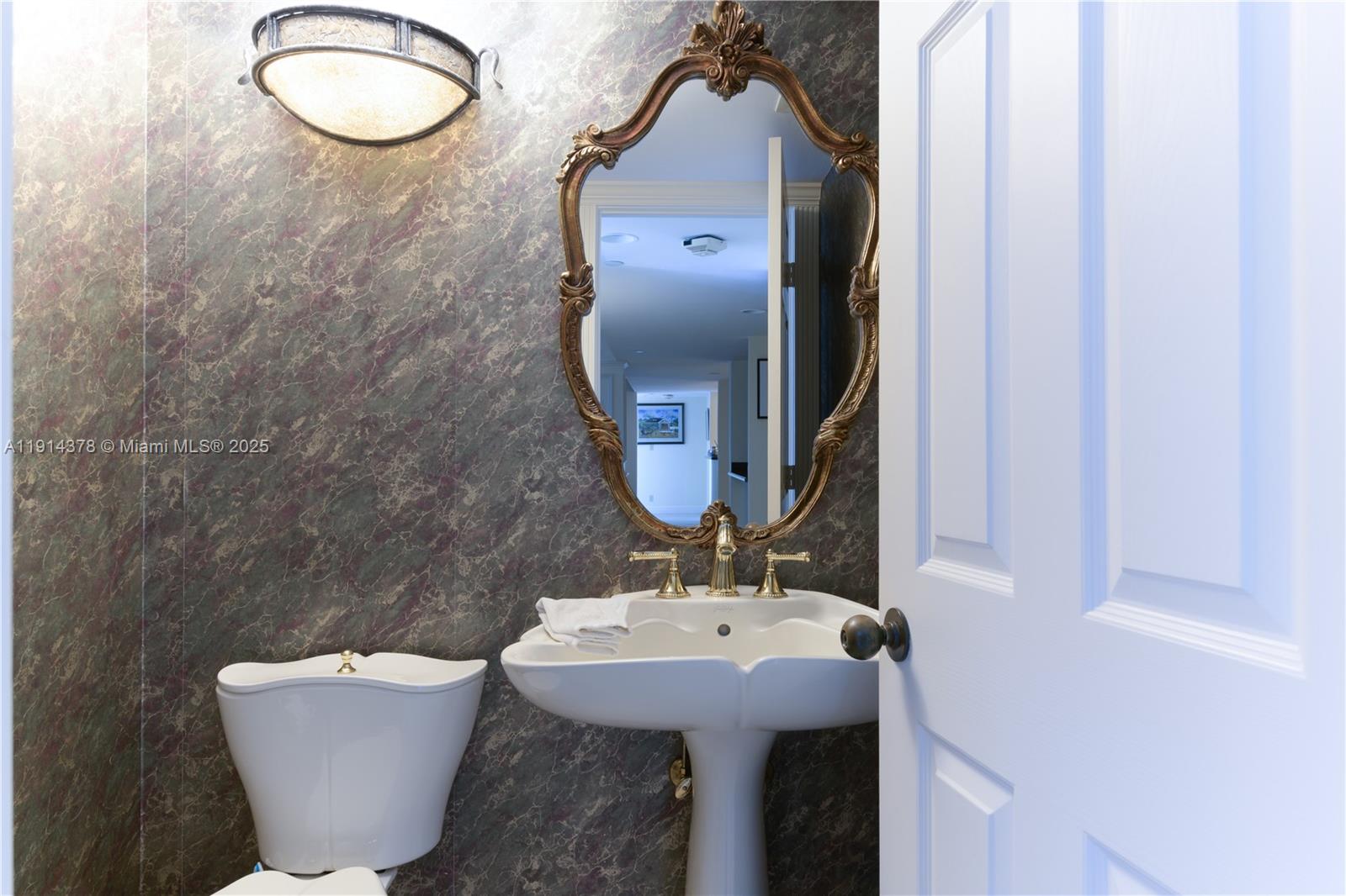 19670 South Beach Road, Unit PHB3 Tequesta, FL 33469 - Photo 29 of 38 a bathroom with a sink and mirror