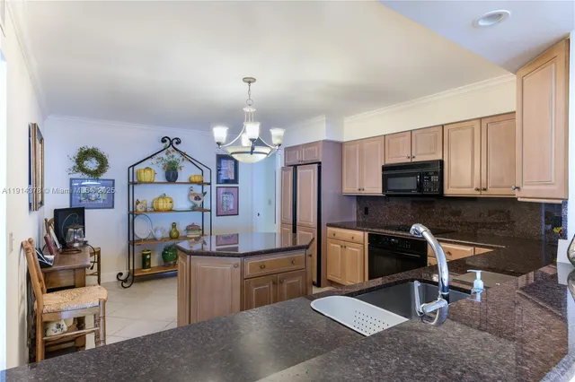 a view of kitchen with cabinets stainless steel appliances and wooden floor