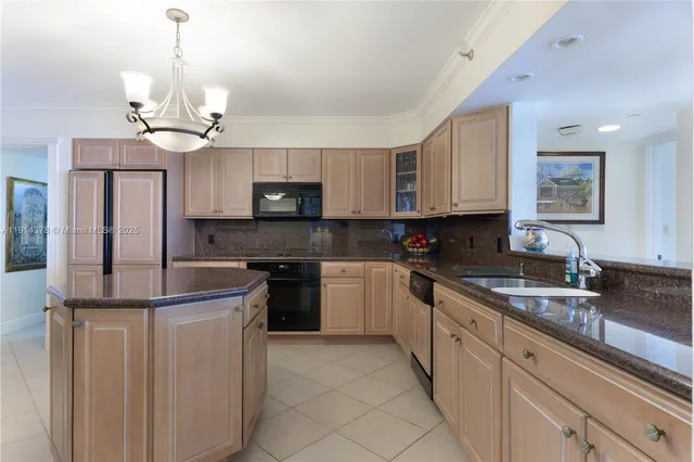 a kitchen with kitchen island granite countertop a sink stainless steel appliances and white cabinets