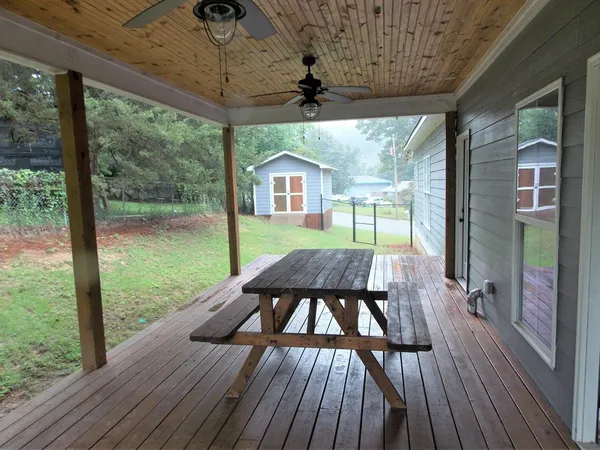 a view of a porch with wooden floor and outdoor space